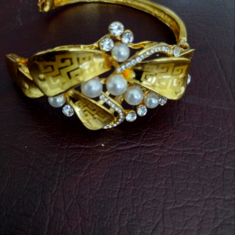 Gold bracelet design with pearl-like and Egypt markings art